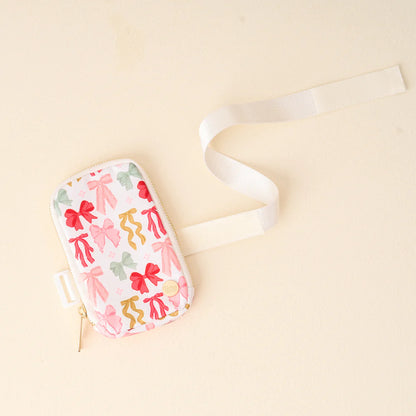 bow affair tumbler fanny pack arranged on a off-white background.