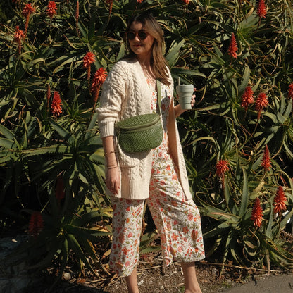 person standing in a park with sweet basil juno bag worn as a crossbody.