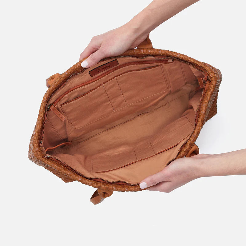 hands holding open bolder tote showing interior.