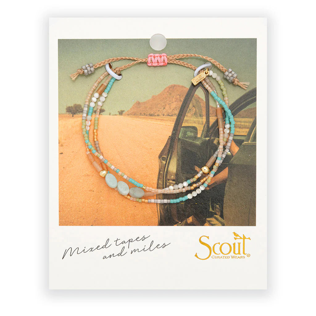 beaded bracelets in pink, teal, and beige hues on card packaging