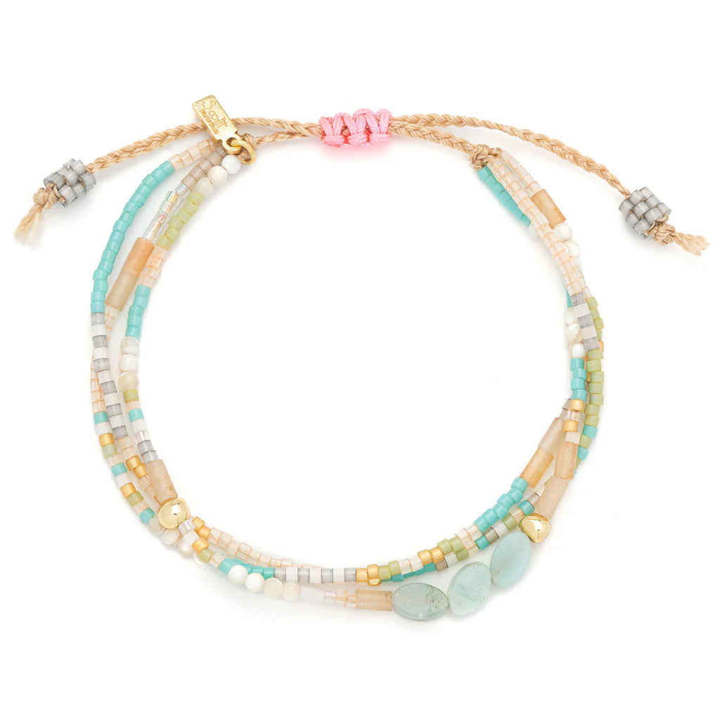 beaded bracelets in pink, teal, and beige hues shown on a white background
