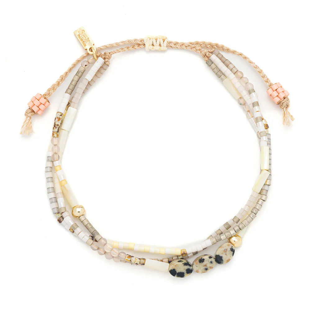 beaded bracelets in earthy brown and white hues shown on a white background