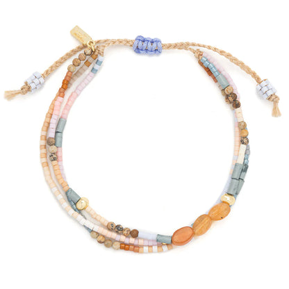beaded bracelets in pastel hues of pinks, blues, and browns shown on a white background