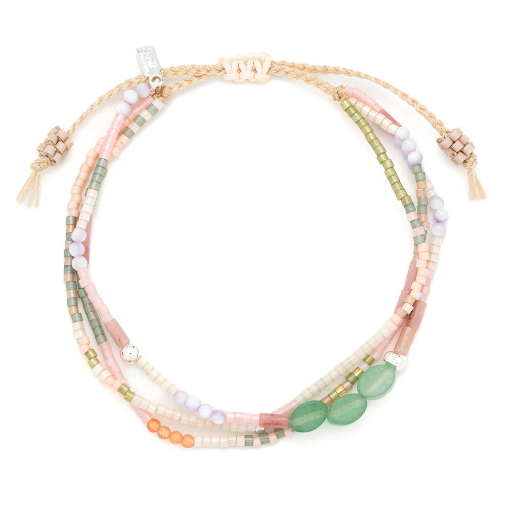 beaded bracelets in earthy hues of pink and green shown on a white background