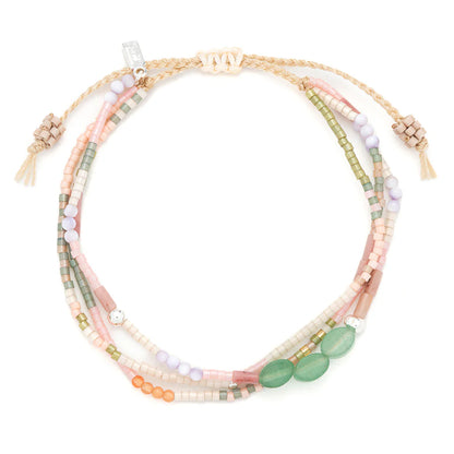 beaded bracelets in earthy hues of pink and green shown on a white background