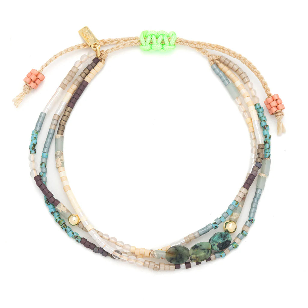beaded bracelets in earthy hues of browns and blue shown on a white background