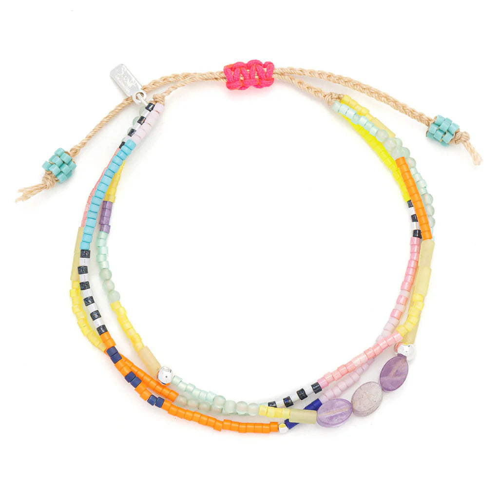 beaded bracelets in a rainbow of hues hues shown on a white background
