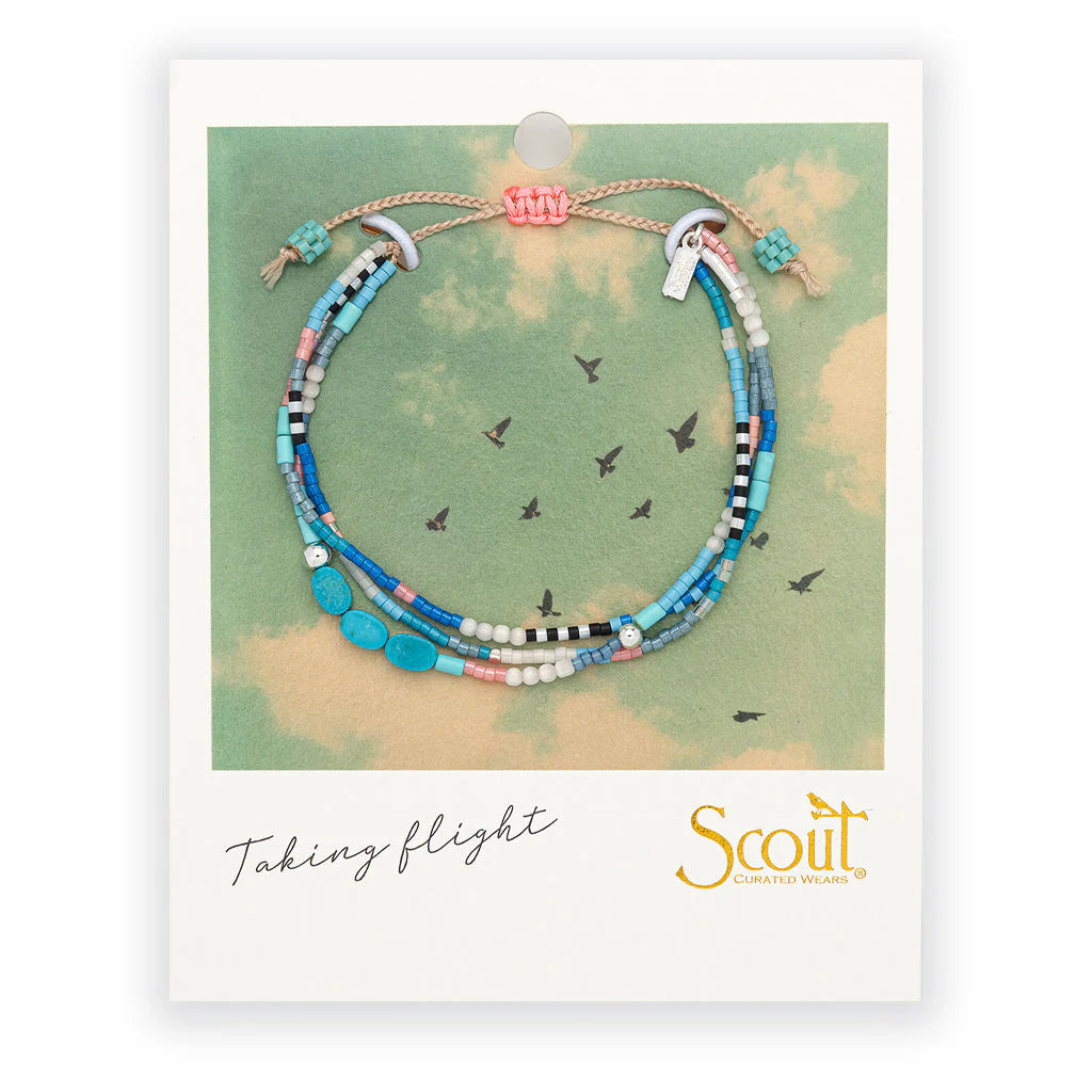 beaded bracelets in bright blue and teal hues on card packaging
