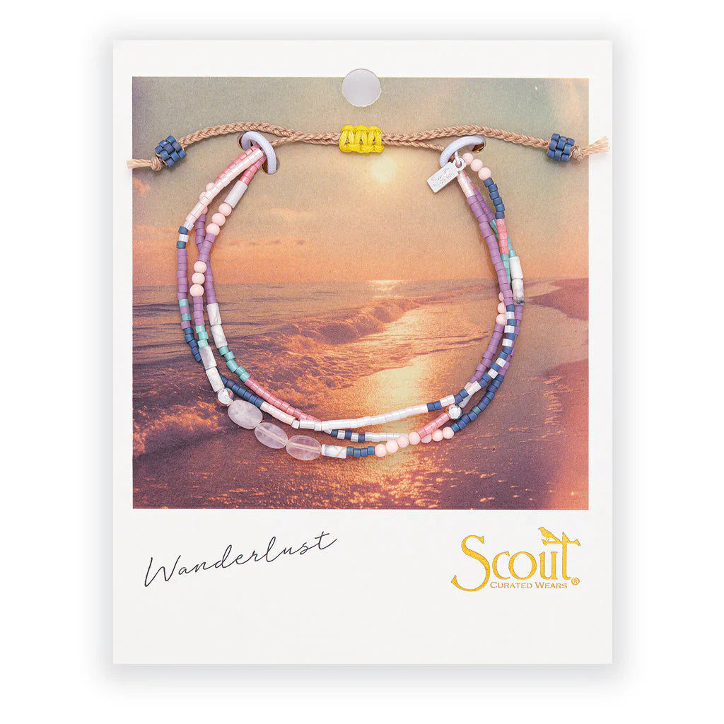 beaded bracelets in pink, purple, and white hues on card packaging
