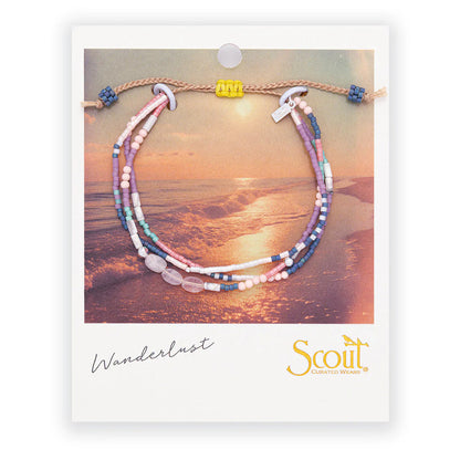 beaded bracelets in pink, purple, and white hues on card packaging
