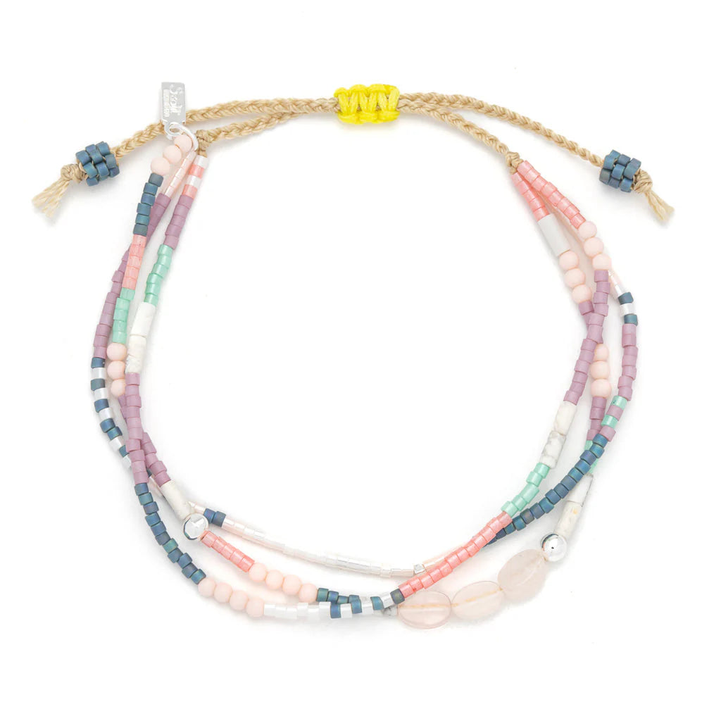 beaded bracelets in pink, purple, and white hues shown on a white background