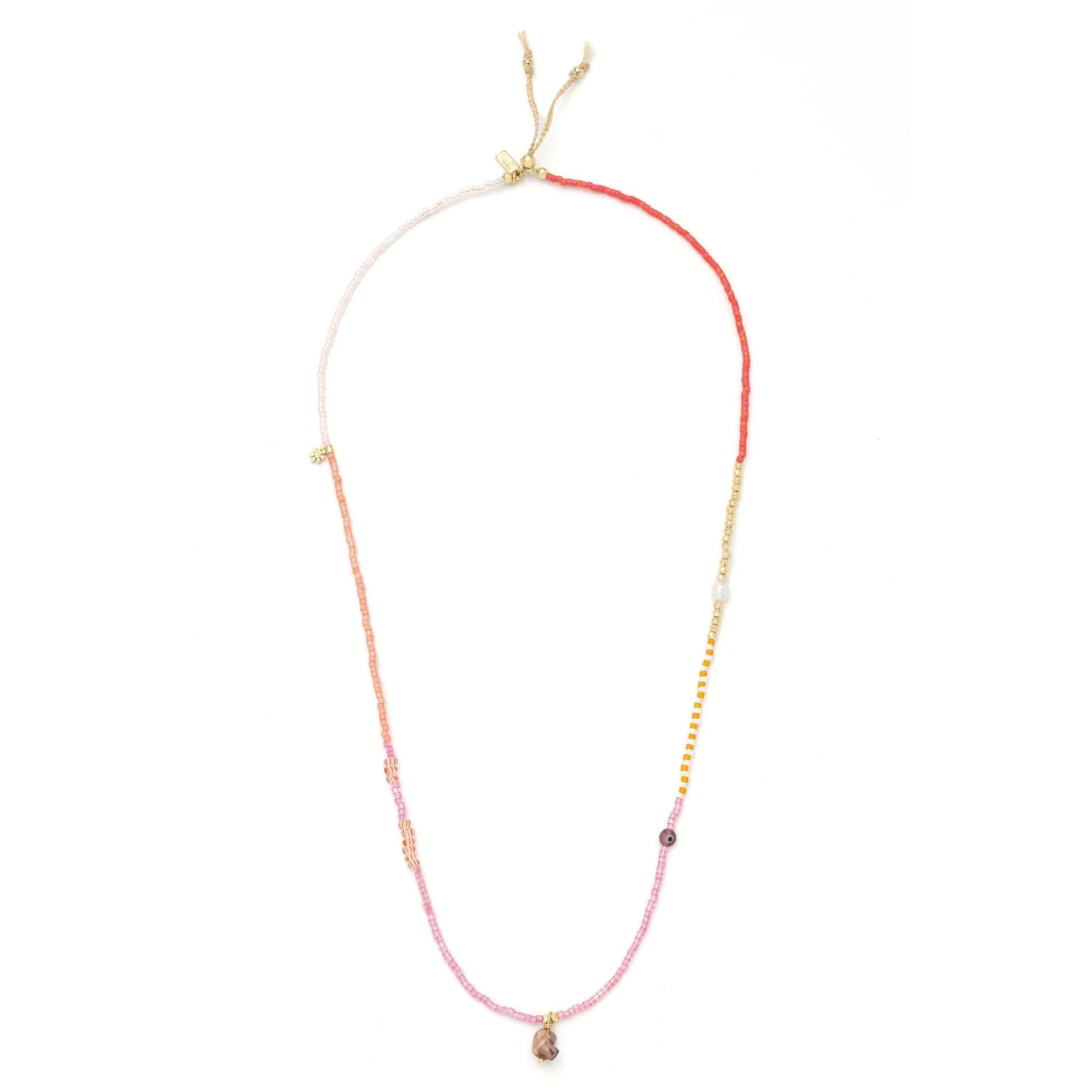 beaded wrap in pink and gold hues shown laying as a necklace on a white background
