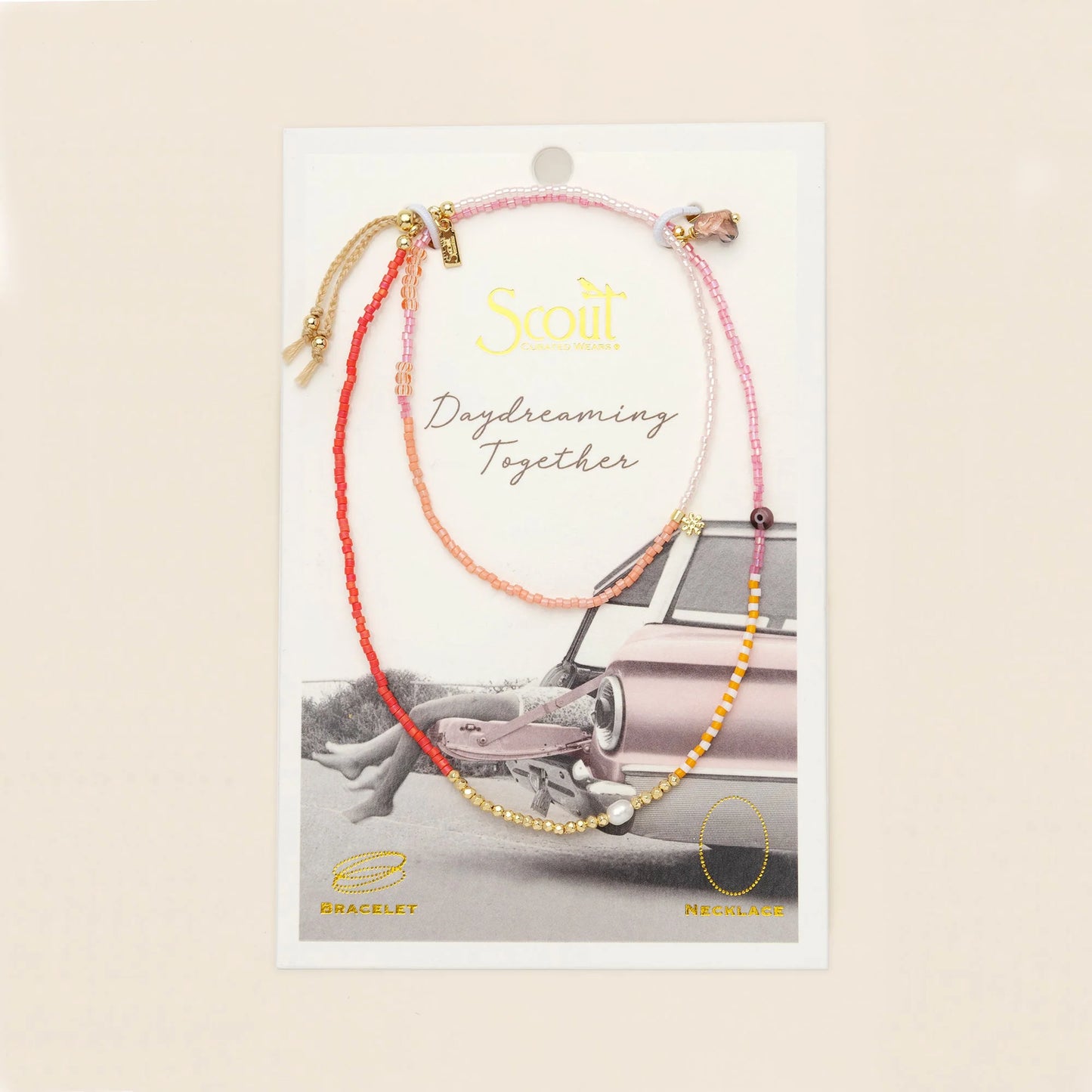beaded wrap in pink and gold hues with accent beads on its card packaging

