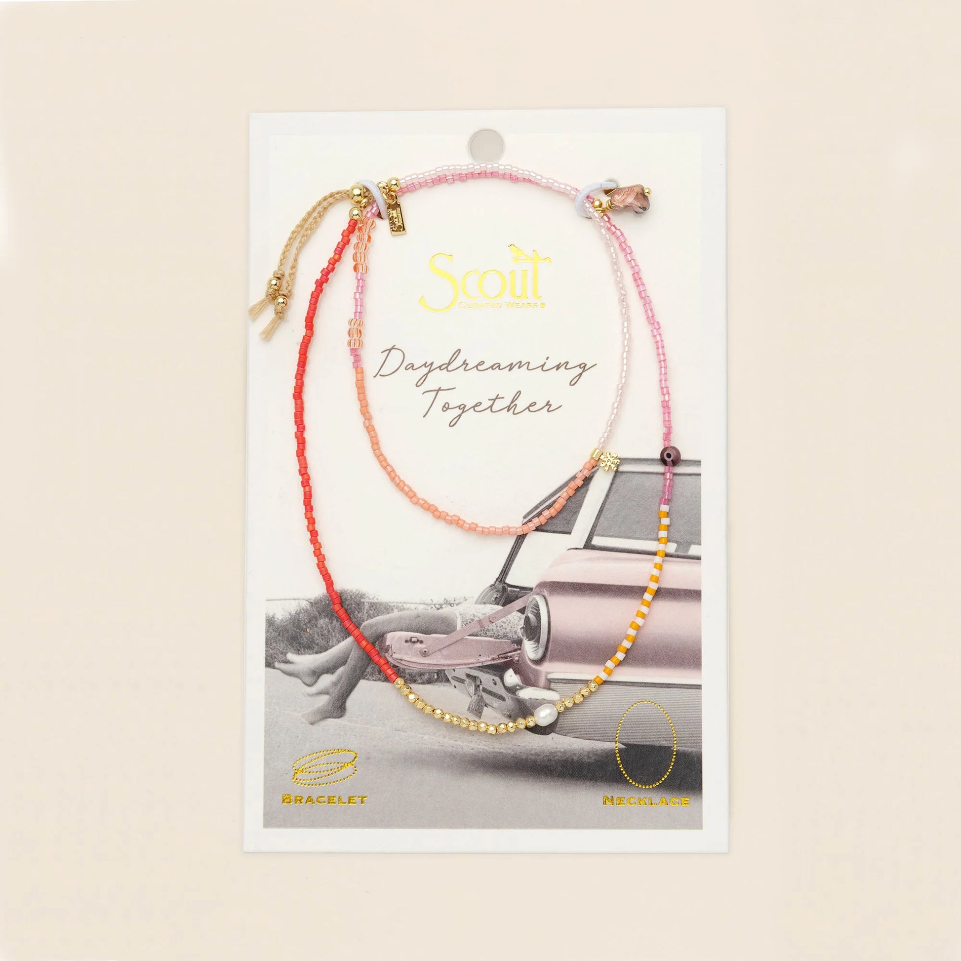 beaded wrap in pink and gold hues with accent beads on its card packaging
