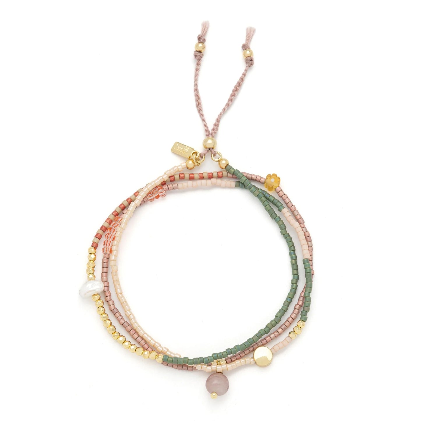 beaded wrap in pink, green, and gold hues shown laying as a triple layered bracelet on a white background
