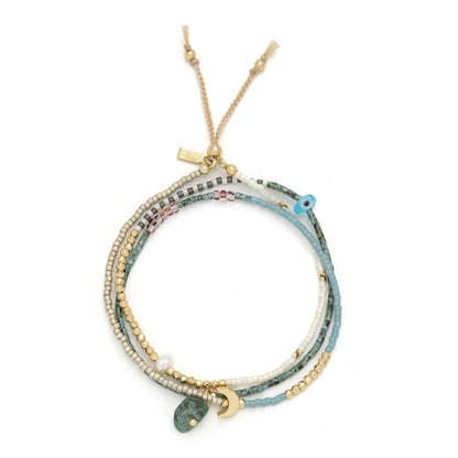 beaded wrap in blue, green, gold, and white hues shown laying as a triple layered bracelet on a white background
