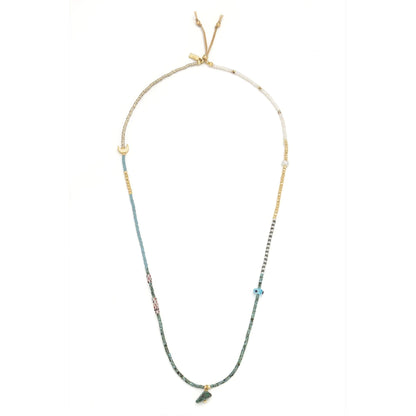 beaded wrap in blue, green, gold, and white hues shown laying as a necklace on a white background
