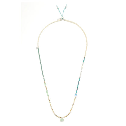beaded wrap in dreamy green hues shown laying as a necklace on a white background

