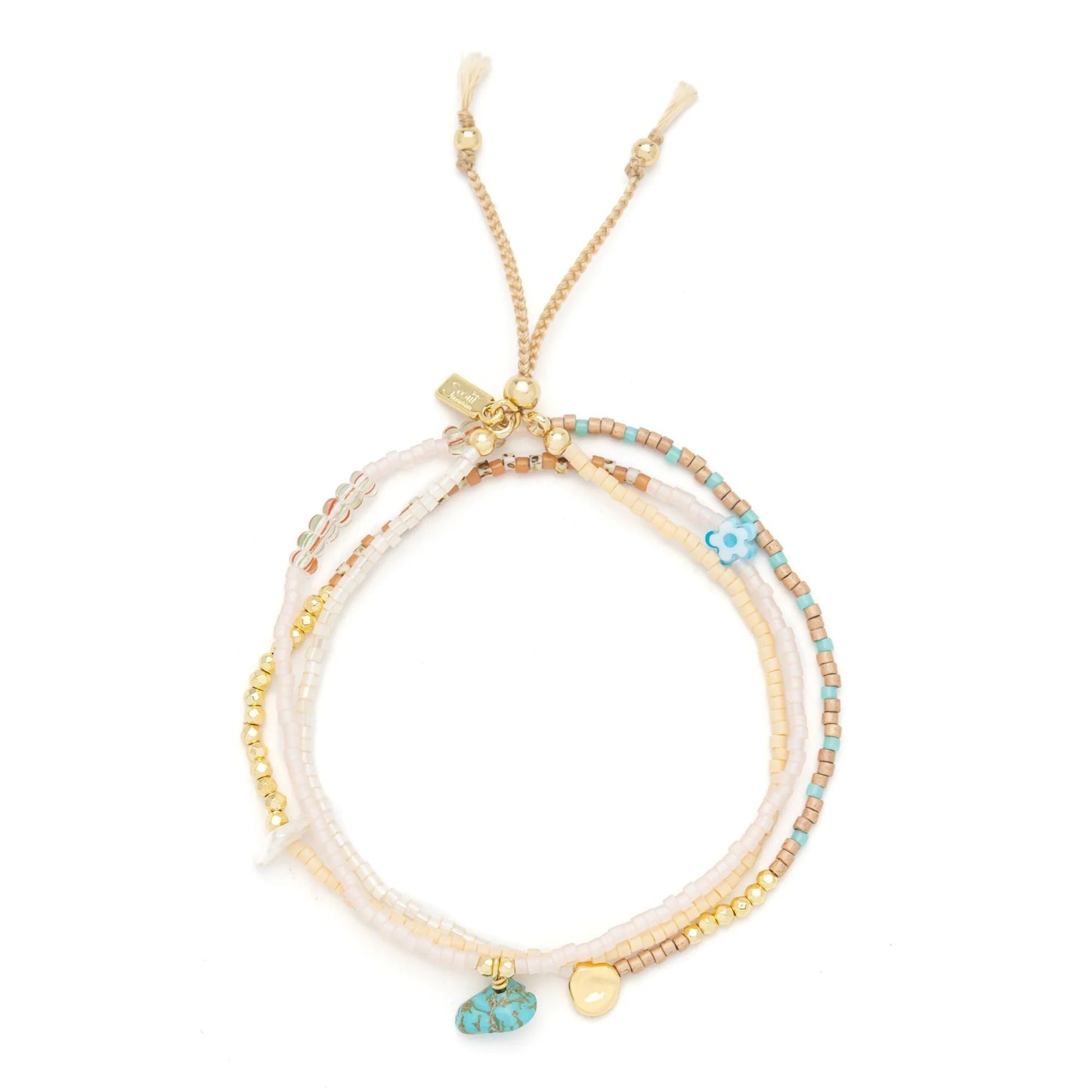 beaded wrap in blush pink and gold hues shown laying as a triple layered bracelet on a white background
