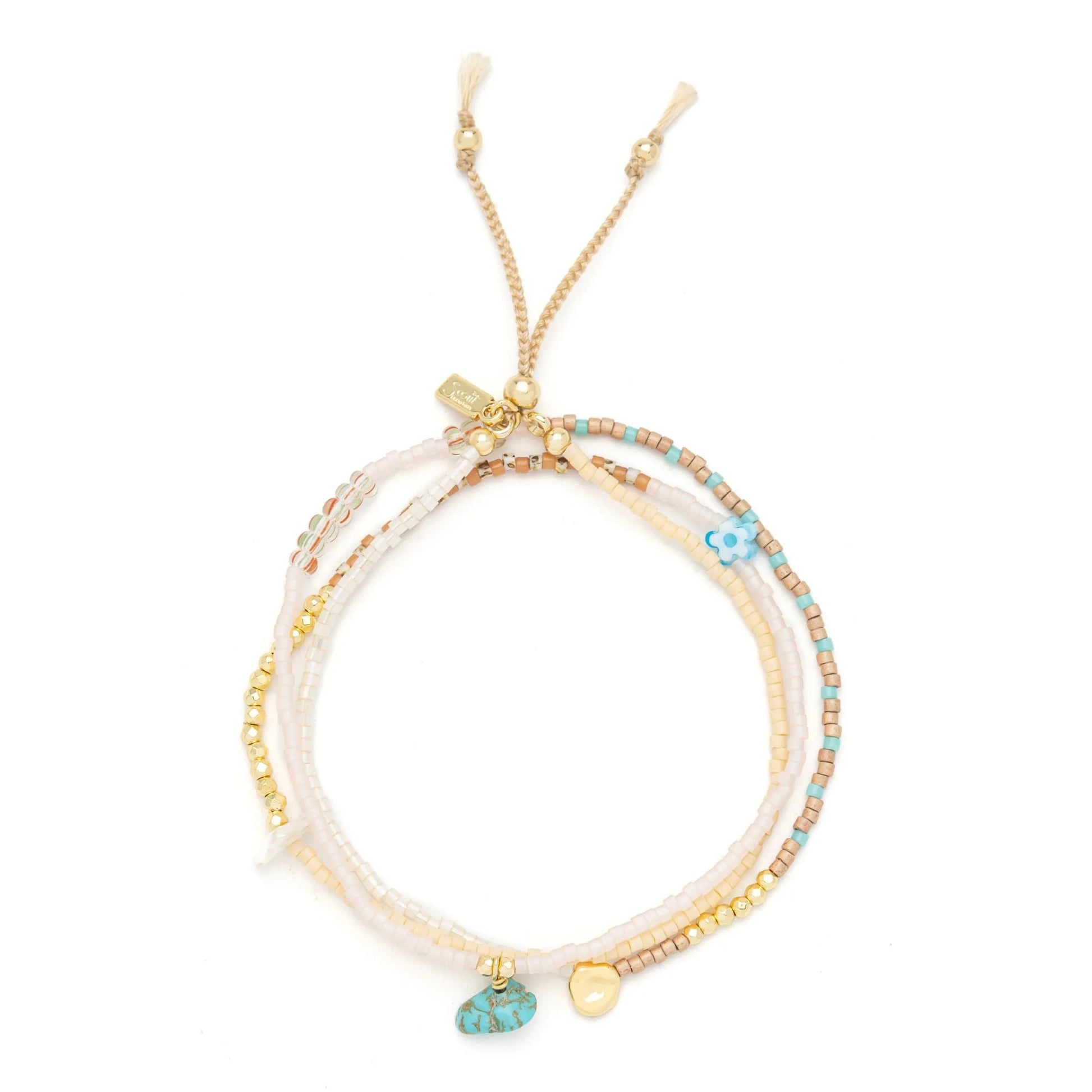 beaded wrap in blush pink and gold hues shown laying as a triple layered bracelet on a white background
