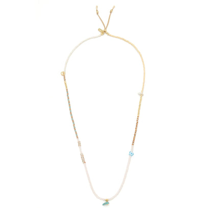 beaded wrap in blush pink and gold hues shown laying as a necklace on a white background
