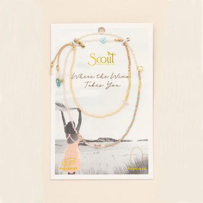 beaded wrap in blush pink and gold hues with accent beads on its card packaging
