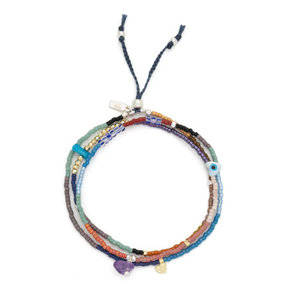 beaded wrap in a rainbow of hues shown laying as a triple layered bracelet on a white background
