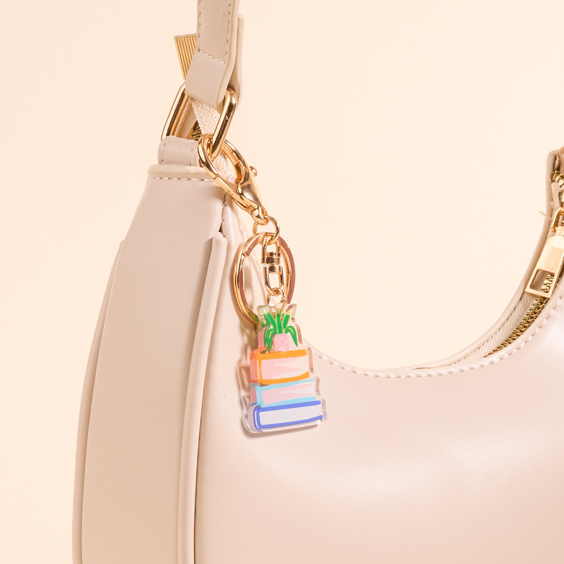 Acrylic book Nook keychain on a pink purse