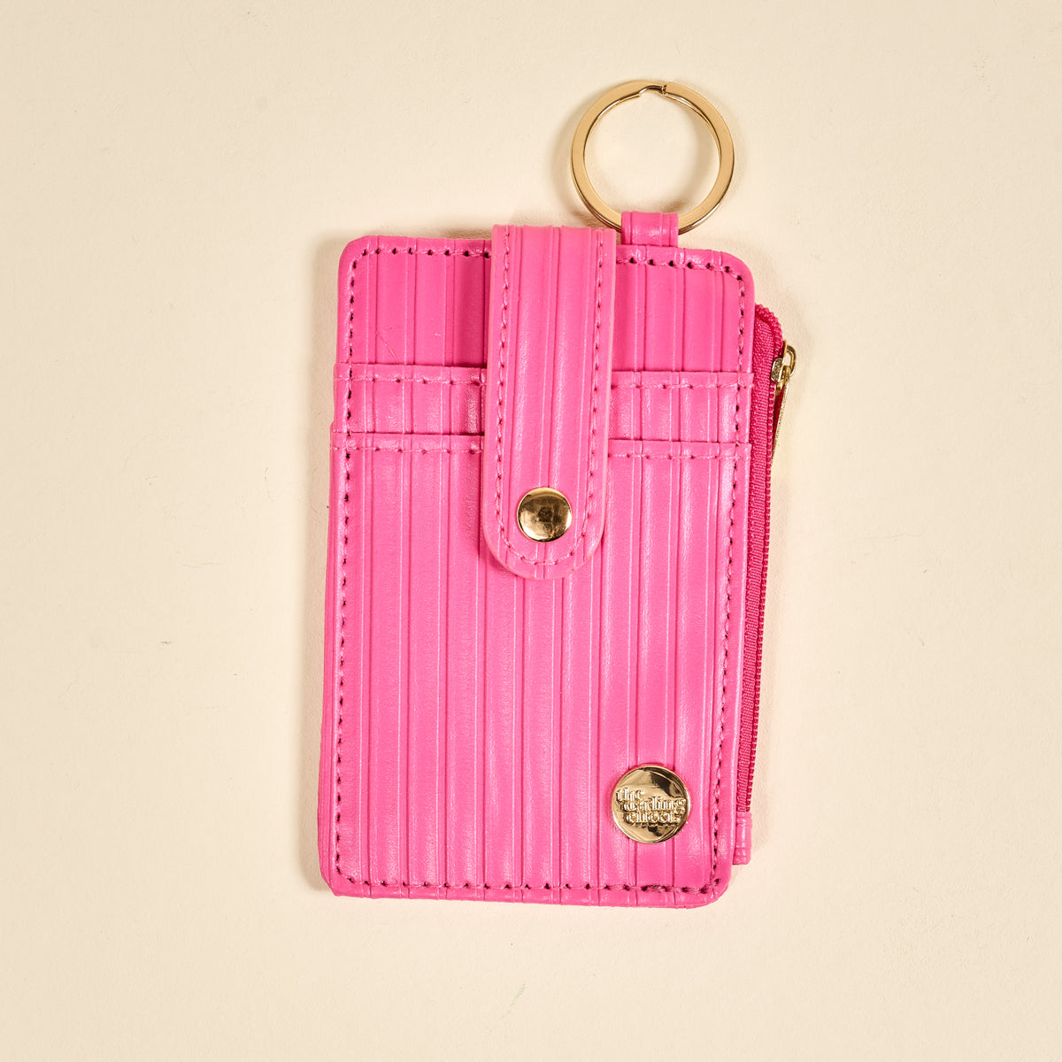 Ripple Ridge Keychain Wallet in Hot Pink on a beige background