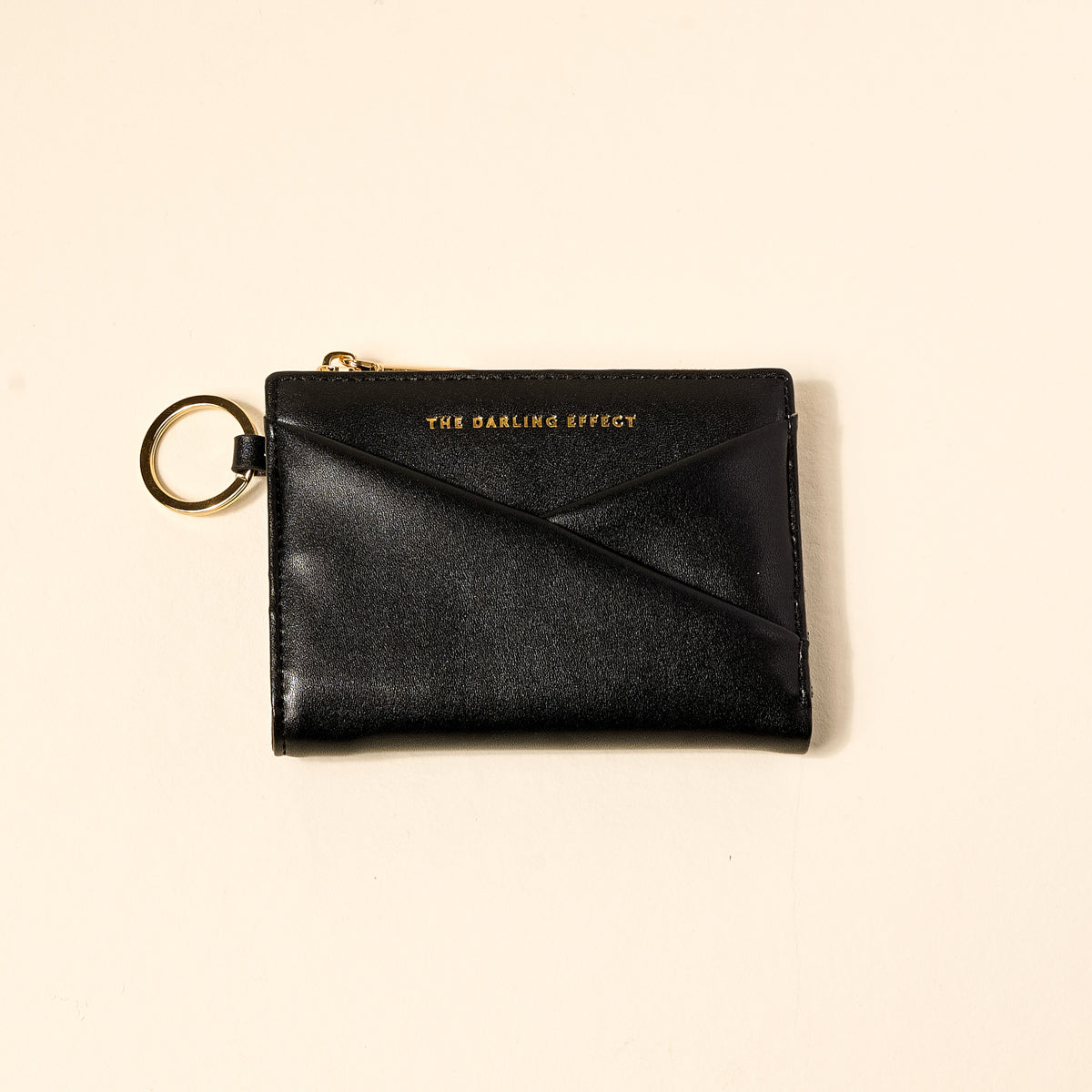 black luxe pocket wallet on a beige background