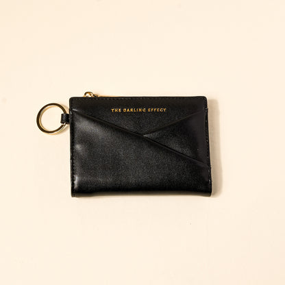 black luxe pocket wallet on a beige background