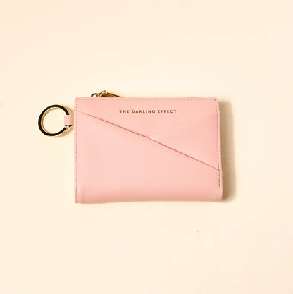 blush colored luxe pocket wallet on a beige background