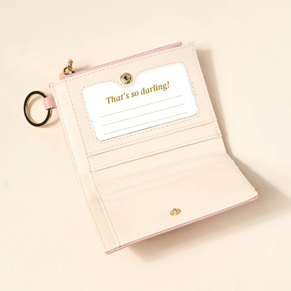 blush colored luxe pocket wallet opened up on a beige background