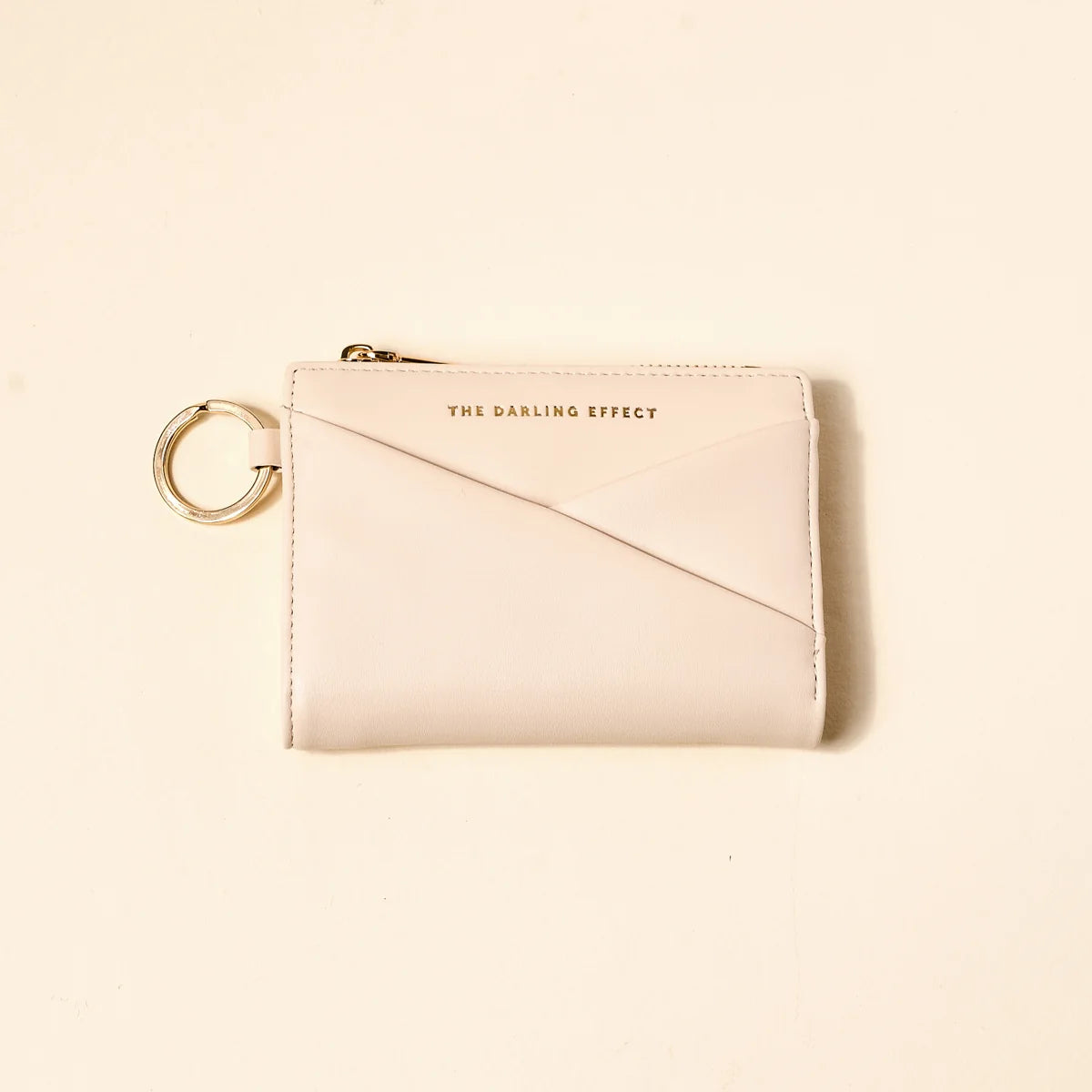 oat colored luxe pocket wallet on a beige background