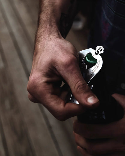 hand using PocketMonkey tool to open a bottle