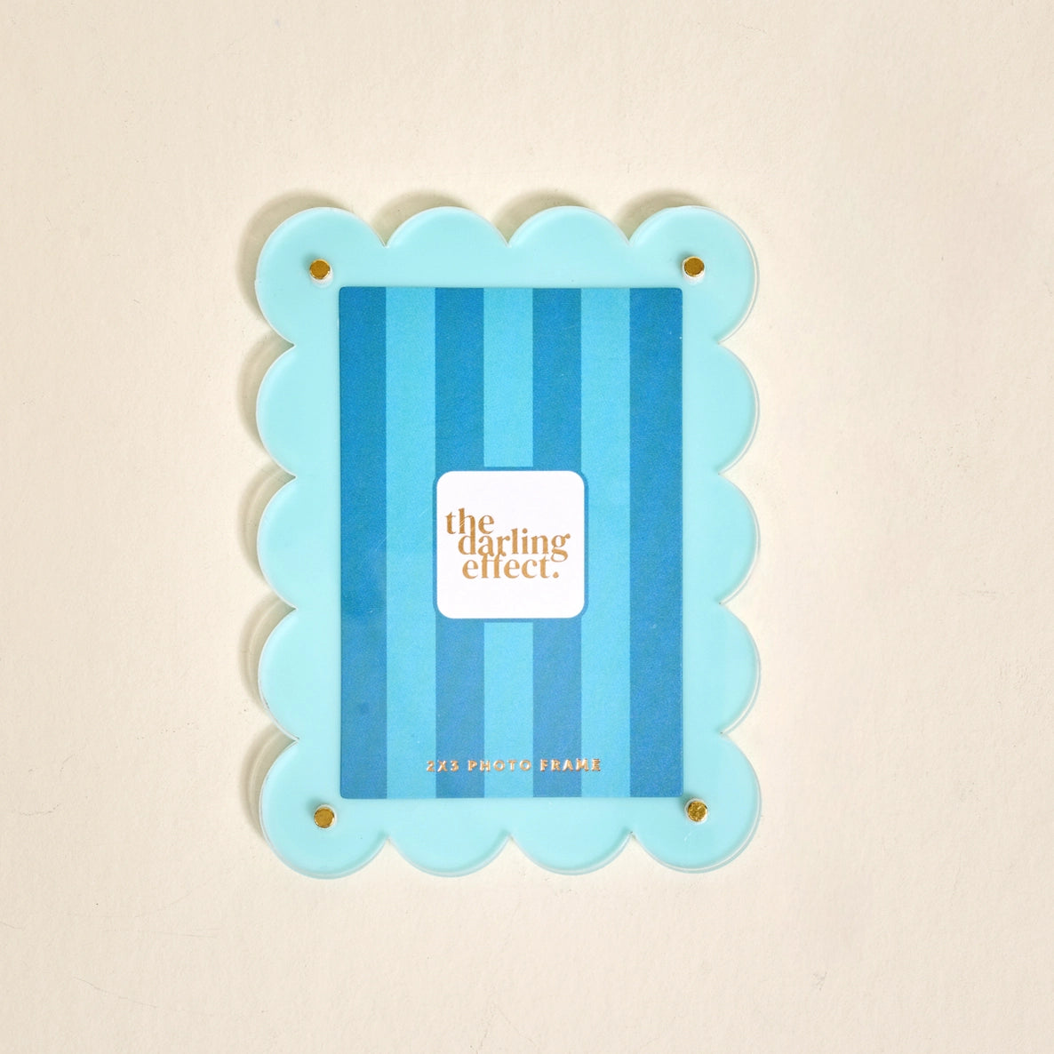 Scalloped light blue magnetic frame against a white background.