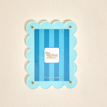 Scalloped light blue magnetic frame against a white background.