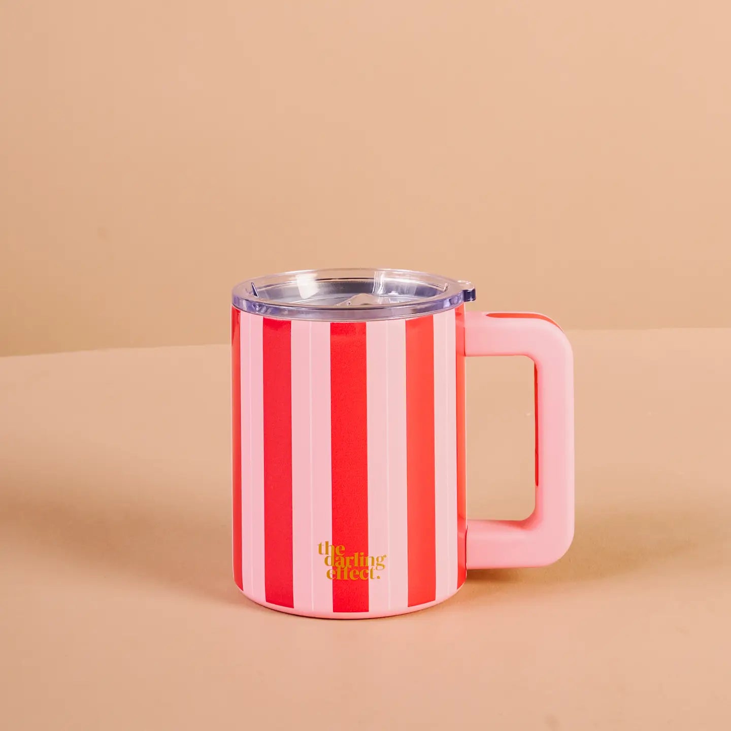 Red and pink striped insolated  mug with a pink handle on a beige background