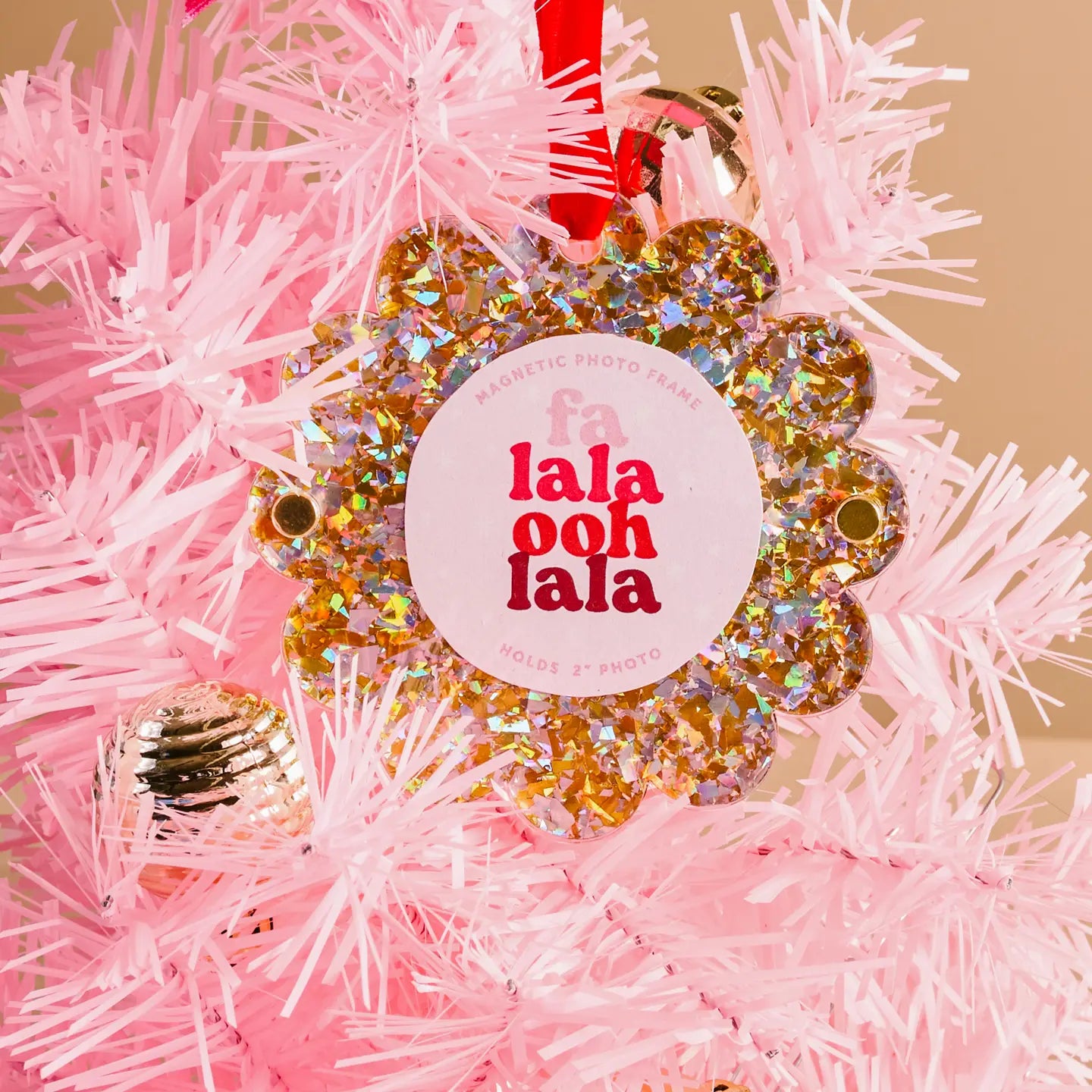 gold glitter Scalloped Acrylic Frame Ornament hung by a red ribbon in a pink tinsel tree
