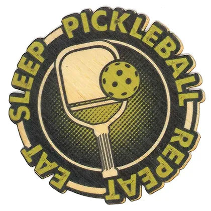 light wood and green colored pickleball paddle and pickleball ball on a black background with text circling image saying "eat sleep pickleball repeat" 