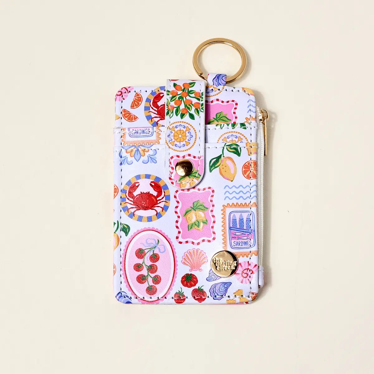 Colorful keychain pouch with various designs on a beige background