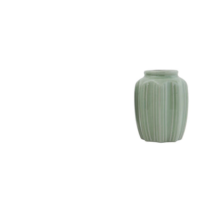 small jade green vase with ribbed  pattern on a white background