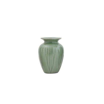 small jade green vase with leaf pattern on a white background