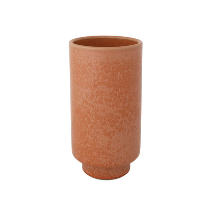 pale orange colored ceramic vase on a white background