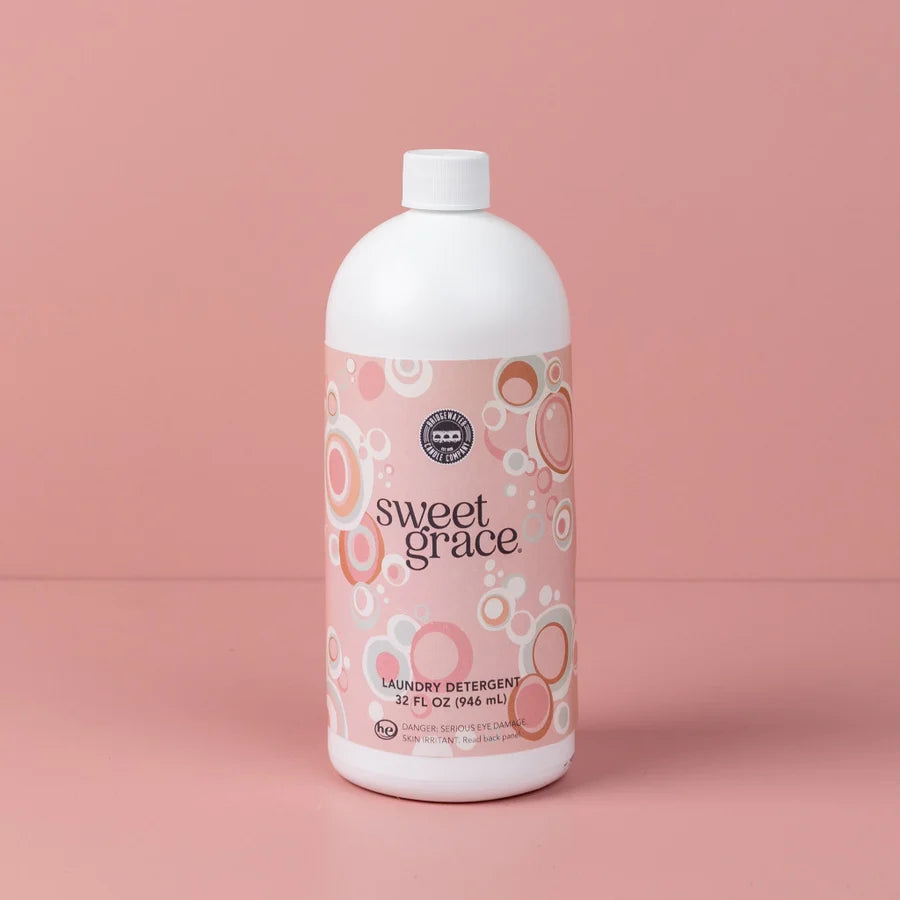 Bottle of Sweet Grace laundry detergent on a pink background