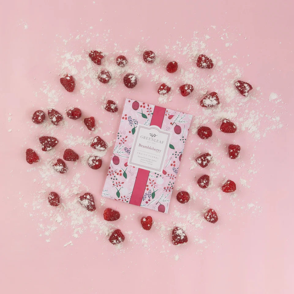 Brambleberry Large Sachet arranged on a pink background with sugar dusted raspberries.