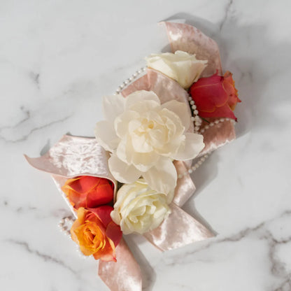 top view of Cashmere Kiss Flower Diffuser with roses around it set on a marble surface