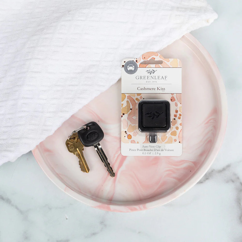 Cashmere Kiss Auto Vent Clip laying on a light pink tray with car keys