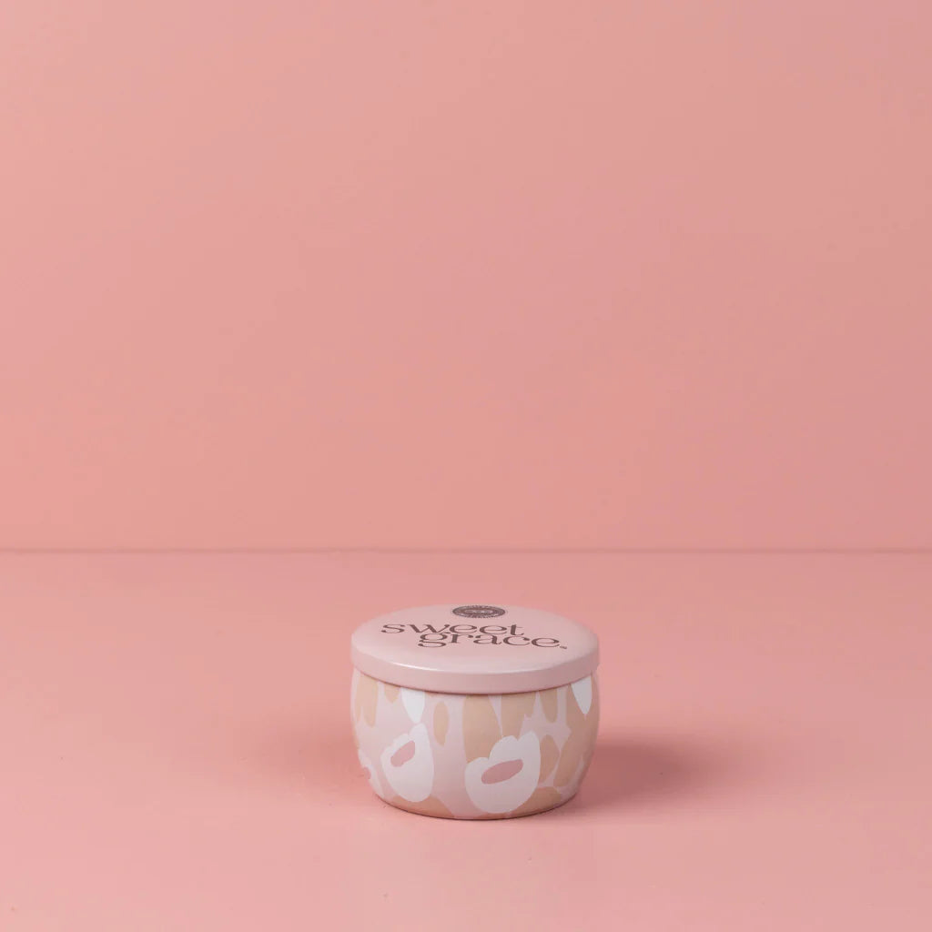 Sweet Grace Floral Tin Candle shown on a pink background