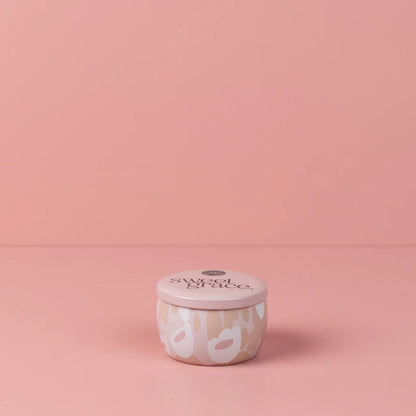 Sweet Grace Floral Tin Candle shown on a pink background